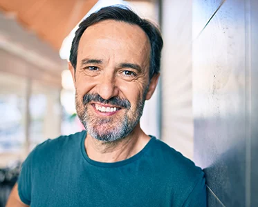 Middle-aged man smiling.